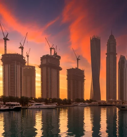 Dubai skyline at sunset with cranes illustrating off-plan developments