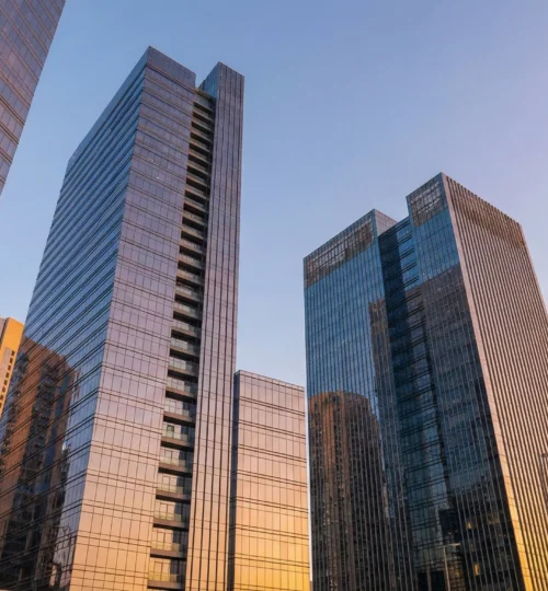 Modern glass office buildings in Dubai symbolizing commercial real estate investment.
